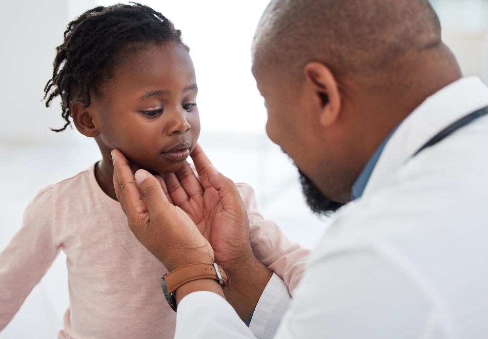 A doctor gently examining a young child