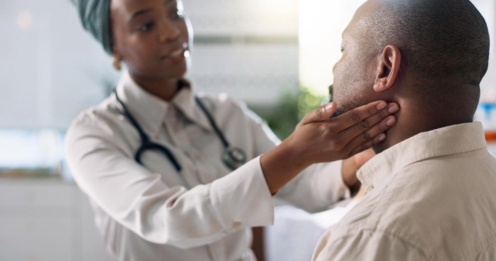A doctor examining a patient's neck